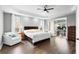 Spacious main bedroom with a tray ceiling, hardwood floors, and access to an adjoining office area at 12736 Lake Ridge Cir, Clermont, FL 34711