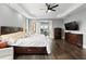 Well-lit main bedroom with a ceiling fan, hardwood floors, and neutral decor, providing a relaxing retreat at 12736 Lake Ridge Cir, Clermont, FL 34711