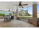 Spacious screened patio with ample seating, ideal for outdoor dining and entertaining with a view of lush greenery at 12736 Lake Ridge Cir, Clermont, FL 34711