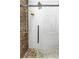 Close-up of a stone-tiled shower with a glass door and a rainfall shower head fixture at 12736 Lake Ridge Cir, Clermont, FL 34711