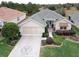 Aerial view of a single Gathering home featuring an attached two car garage and manicured lawn at 12841 Se 97Th Terrace Rd, Summerfield, FL 34491