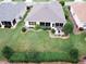 Aerial view of a backyard featuring an umbrella covered table and a lush manicured green lawn at 12841 Se 97Th Terrace Rd, Summerfield, FL 34491