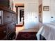 View of bedroom dresser, artwork, with hallway leading to bathroom and office space at 12841 Se 97Th Terrace Rd, Summerfield, FL 34491