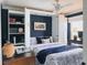 This office bedroom features navy walls and custom built-in shelving with lighting at 12841 Se 97Th Terrace Rd, Summerfield, FL 34491
