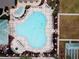 Aerial shot of a community pool with a uniquely shaped pool and plenty of lounge chairs at 12841 Se 97Th Terrace Rd, Summerfield, FL 34491