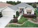 Well-maintained single-story home with mature landscaping, complemented by a two-car garage at 12841 Se 97Th Terrace Rd, Summerfield, FL 34491