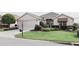 Charming single Gathering home with a manicured lawn, lush landscaping, and a two car garage at 12841 Se 97Th Terrace Rd, Summerfield, FL 34491