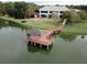 Picturesque gazebo on a lake with boardwalk, with a view of the clubhouse in the background at 12841 Se 97Th Terrace Rd, Summerfield, FL 34491