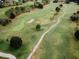 Overhead view of a well-manicured golf course surrounded by lush greenery and trees at 12841 Se 97Th Terrace Rd, Summerfield, FL 34491