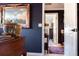 Stylish hallway features dark blue accent wall and leads to rooms with detailed accents and views at 12841 Se 97Th Terrace Rd, Summerfield, FL 34491