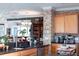 Well-appointed kitchen with sleek countertops, stainless steel appliances, and exposed brick accents at 12841 Se 97Th Terrace Rd, Summerfield, FL 34491