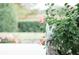 Decorative bunny garden statue nestled among flowers and green plants adds charm to the landscape at 12841 Se 97Th Terrace Rd, Summerfield, FL 34491