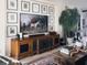 Elegant living room features a large TV, wooden cabinet, and beautifully decorated coffee table at 12841 Se 97Th Terrace Rd, Summerfield, FL 34491