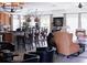 Bright living room featuring a bar with stools, multiple armchairs, and neutral colors at 12841 Se 97Th Terrace Rd, Summerfield, FL 34491