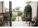 Inviting patio featuring wrought iron gate, bistro table, chairs, and well-maintained landscaping at 12841 Se 97Th Terrace Rd, Summerfield, FL 34491