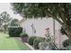 Beautiful side yard featuring lush landscaping with flowering bushes and manicured shrubbery at 12841 Se 97Th Terrace Rd, Summerfield, FL 34491