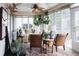 Bright sunroom with stylish decor, potted plants, ample seating, and plenty of natural light at 12841 Se 97Th Terrace Rd, Summerfield, FL 34491