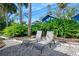 Backyard with lounge chairs, lush tropical landscaping, and a serene atmosphere perfect for relaxation at 13 Sandcastle Dr, Ormond Beach, FL 32176