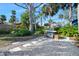 Backyard featuring a grill, tropical landscaping, and a stone walkway, perfect for outdoor gatherings and relaxation at 13 Sandcastle Dr, Ormond Beach, FL 32176
