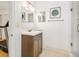 Bathroom featuring a single vanity and a glimpse of a treadmill in the adjacent room at 13 Sandcastle Dr, Ormond Beach, FL 32176