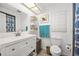 Clean bathroom featuring a vanity with storage, a toilet, and decorative accents at 13 Sandcastle Dr, Ormond Beach, FL 32176