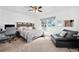 This bedroom features neutral carpet, a ceiling fan, and a desk at 13 Sandcastle Dr, Ormond Beach, FL 32176