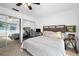 This bedroom features neutral carpet, a ceiling fan, and mirrored closet doors at 13 Sandcastle Dr, Ormond Beach, FL 32176