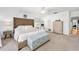 Serene bedroom featuring a bed with a tufted headboard, a ceiling fan, and ample natural light at 13 Sandcastle Dr, Ormond Beach, FL 32176