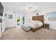 Spacious bedroom featuring a tufted headboard, a ceiling fan, and patio access at 13 Sandcastle Dr, Ormond Beach, FL 32176