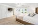 Bedroom view with a door to a bathroom, a view to the backyard, and a comfortable bed at 13 Sandcastle Dr, Ormond Beach, FL 32176