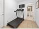 Bonus room area with a treadmill, adjacent to a bathroom at 13 Sandcastle Dr, Ormond Beach, FL 32176