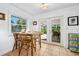 Charming eat-in kitchen featuring a square table with chairs and glass doors to the outdoor living space at 13 Sandcastle Dr, Ormond Beach, FL 32176
