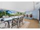 Large covered patio featuring an outdoor dining area, bar seating, and views of the backyard landscaping at 13 Sandcastle Dr, Ormond Beach, FL 32176