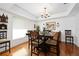 Dining room features wood floors, a large wood table, six chairs, and natural light at 13 Sandcastle Dr, Ormond Beach, FL 32176