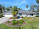 Charming single-story home with a well-manicured lawn and a beautiful garden in front at 13 Sandcastle Dr, Ormond Beach, FL 32176