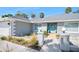Charming exterior with tidy landscaping, blue door, and attached two-car garage at 13 Sandcastle Dr, Ormond Beach, FL 32176