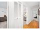 Hallway view featuring wood floors, closet, and doorway into the bedroom and living room at 13 Sandcastle Dr, Ormond Beach, FL 32176