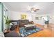 Bright living room featuring hardwood floors, neutral paint, and stylish furniture with easy access to the dining and kitchen areas at 13 Sandcastle Dr, Ormond Beach, FL 32176