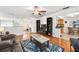 Comfortable living room with a ceiling fan, hardwood floors, modern decor, and an open layout to the kitchen area at 13 Sandcastle Dr, Ormond Beach, FL 32176
