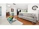 Comfortable living room with hardwood floors, gray sofa, and easy access to other rooms at 13 Sandcastle Dr, Ormond Beach, FL 32176