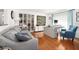 Bright and airy office space with hardwood floors, large window, gray sofa, and custom shelving at 13 Sandcastle Dr, Ormond Beach, FL 32176