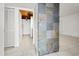 Bright hallway featuring tiled floors, slate accent wall and access to kitchen at 140 Orchid Woods Ct # 7A, Deltona, FL 32725