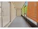 Enclosed patio featuring a concrete floor, screened windows, and sliding doors leading to a bright indoor space at 140 Orchid Woods Ct # 7A, Deltona, FL 32725