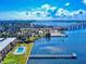 Stunning aerial shot capturing a pool, dock, and waterfront building with a beautiful bridge backdrop at 144 S Halifax Ave # 86, Daytona Beach, FL 32118