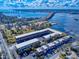 Wide aerial perspective of waterfront condos, highlighting parking, beautiful landscaping and close proximity to the bridge at 144 S Halifax Ave # 86, Daytona Beach, FL 32118