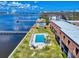 Wide aerial view showcasing condos, a pool, docks and waterfront, set against a coastal backdrop at 144 S Halifax Ave # 86, Daytona Beach, FL 32118