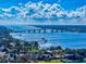 Breathtaking aerial view showcasing the bridge over the intercoastal waterway, the coastal homes, and the expansive blue skies at 144 S Halifax Ave # 86, Daytona Beach, FL 32118