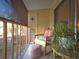 Serene balcony features a cozy chair, small table, and plants for a relaxing outdoor space at 144 S Halifax Ave # 86, Daytona Beach, FL 32118