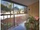 Private balcony overlooking lush landscaping with mature palms, offering a serene outdoor retreat at 144 S Halifax Ave # 86, Daytona Beach, FL 32118