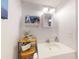 Bathroom featuring a white vanity, framed mirror, nautical decor, and ample lighting at 144 S Halifax Ave # 86, Daytona Beach, FL 32118